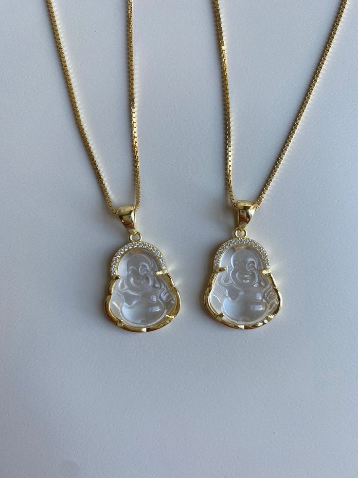 This Clear Quartz Buddha is dainty and perfect for everyday wear! Information: ✨ Sterling Silver (.925 stamped), 14K Gold Plated ✨ Genuine Clear Quartz stone carved with the image of the laughing Buddha ✨ Size: about the size of a quarter, picture for reference ✨ AAA+ Cubic Zirconia stones ✨ Hypoallergenic ✨ Water friendly Clear Quartz: known as a stone of multiple uses, for example, it can amplify energy; absorbing, storing and regulating it. Additionally, it can help you with concentration and Classic Clear Necklaces As Gifts, Classic Clear Necklaces For Gifts, Buddha Necklace, Face Necklace, Gold Aesthetic, Fancy Jewelry, Pearl Charms, Genuine Turquoise, Quartz Stone