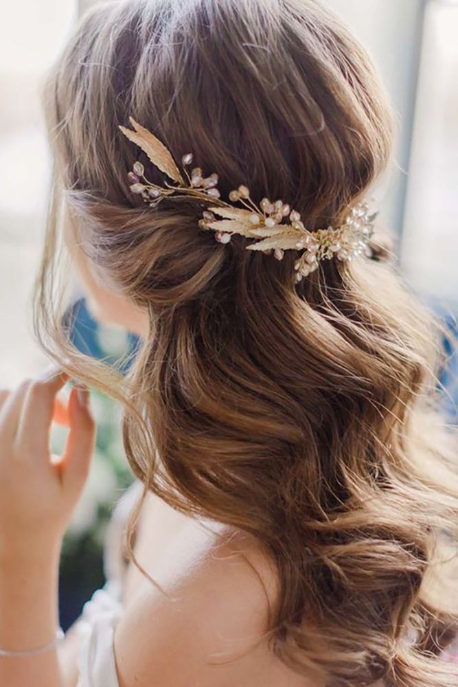 a woman wearing a hair comb with leaves on it