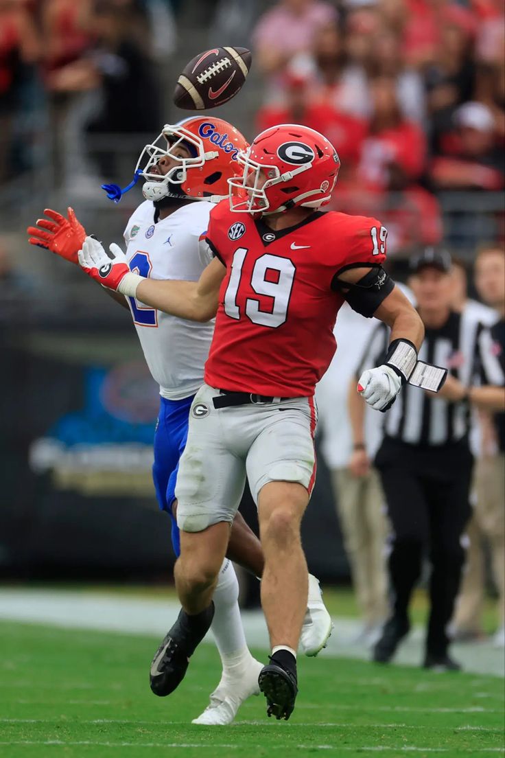 two football players are running on the field