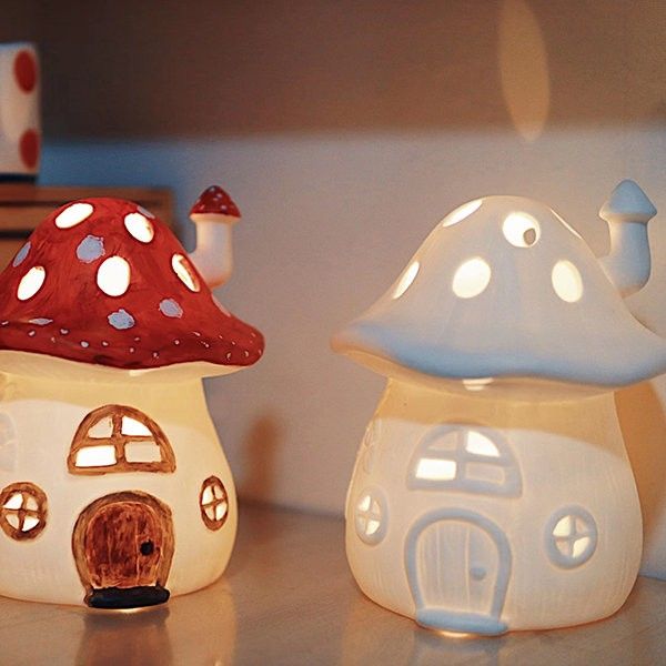 two little lights that look like houses with mushrooms on the roof and one has a dog in it