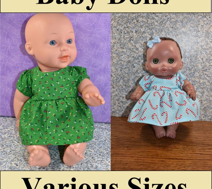 two baby dolls, one in green and the other in blue