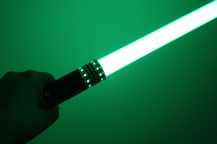 a person is holding a light saber in their right hand and pointing it at the camera