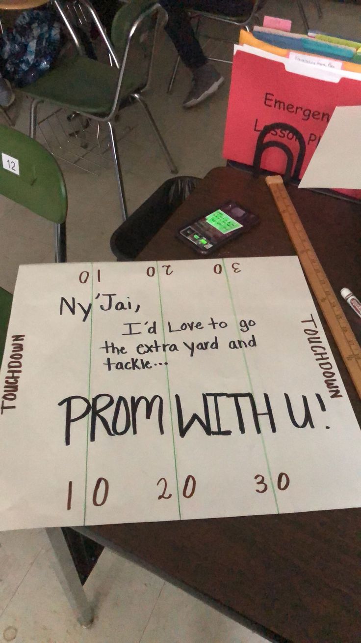 a sign that says prom with u on it in front of some chairs and desks