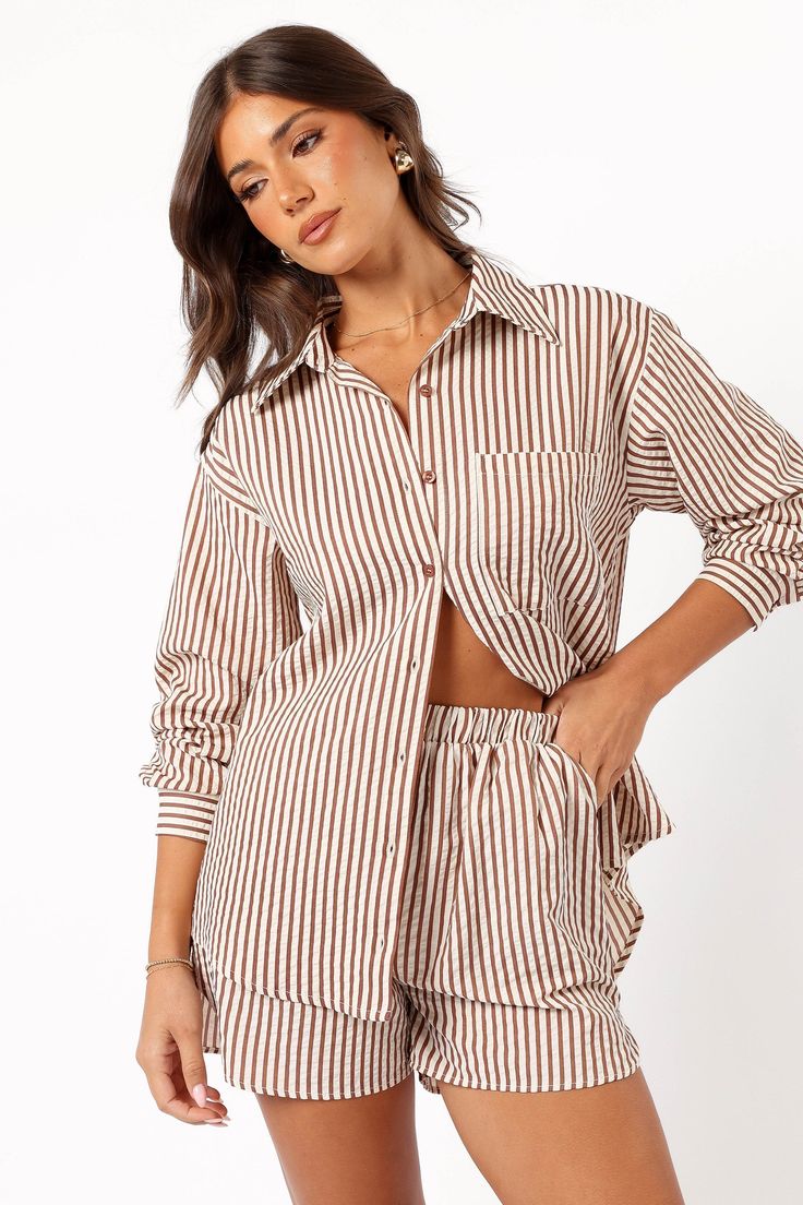 DETAILS    Discover our Kennie Top in Brown Stripe, it's chic relaxed fit is crafted with long sleeves, functional buttons down front, and stylish stripe print â€“ perfect for any season. Unlined for lightweight comfort.    spread collared  long sleeves with button cuff close  functional buttons down front   functional chest pocket  curved hemline  stripe print  relaxed fit  unlined   material - 55% cotton / 45% polyester    SIZING    studio model is 5' 7" and wears a Size S    model stats: bust Striped Tops With Pockets For Daywear, Chic Shirt With Striped Collar And Relaxed Fit, Spring Striped Shirt For Loungewear, Striped Shirt For Spring Loungewear, Spring Loungewear Tops With Vertical Stripes, Chic Relaxed Fit Shirt With Striped Collar, Casual Vertical Stripes Blouse For Fall, Casual Striped Shirt For Loungewear, Long Sleeve Shirt With Vertical Stripes For Day Out