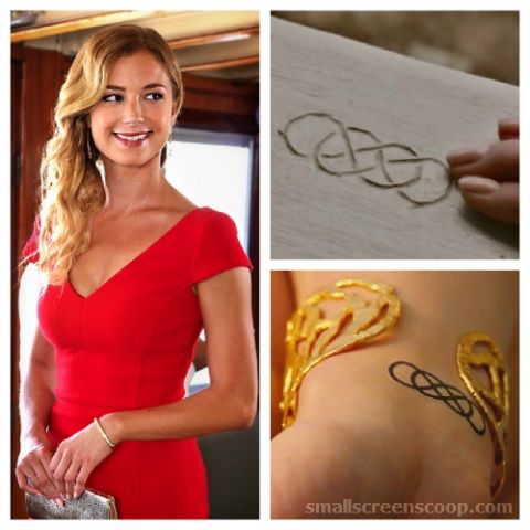 a woman in a red dress wearing gold bracelets and holding a silver purse with the word love written on it