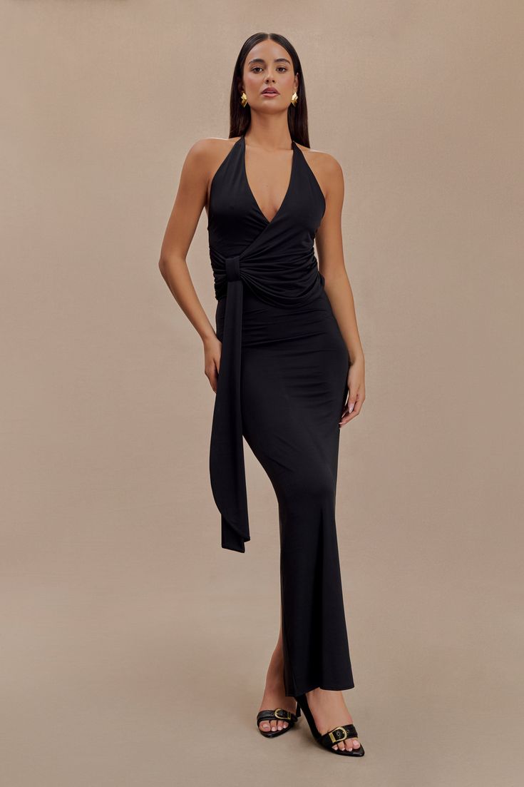 Unforgettable allure. The TYLA Draped Slinky Halter Maxi Dress exudes modern sophistication with its halter neckline and elegant V-front. The draped bodice and tie detail at the hip create a flattering, feminine silhouette, while the open lower back and subtle back split add an irresistible touch. Made from stretch fabric for a comfortable yet sleek fit, Tyla promises graceful movement and effortless style for your most memorable moments. Graceful Movement, Draped Bodice, Halter Maxi Dress, Halter Maxi, Feminine Silhouette, Halter Maxi Dresses, Halter Neckline, Memorable Moments, Lower Back