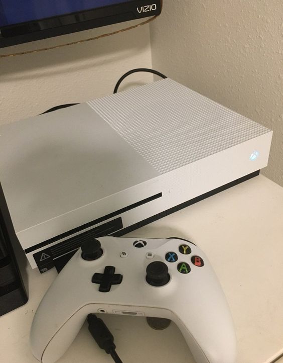 a white video game console sitting on top of a table