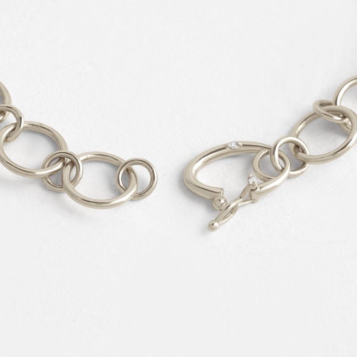 14k gold hand-fabricated link chain with rings alternating from 2mm to 6mm Custom catch clasp set with three 1mm white diamonds (SI clarity) We handcraft each piece with responsibly sourced 14k gold and ethically sourced stones. 7” in total length Timeless Chain Link Bracelet With Lobster Clasp, Sterling Silver Link Chain Ring, White Gold Link Bracelets With Cable Chain Detail, White Gold Link Bracelets With Cable Chain, White Gold Chain Bracelet With Lobster Clasp For Everyday, Silver Diamond Link Bracelet, White Gold Link Bracelet With Cable Chain, White Gold Cable Chain Link Bracelet, Everyday White Gold Chain Bracelet With Lobster Clasp