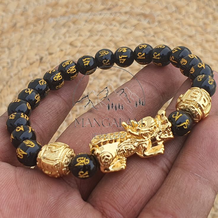 Discover the power of Feng Shui with our Black Obsidian Pixiu Wealth Bracelet. More than a stylish accessory, it's a potent Feng Shui talisman designed to attract wealth and provide protection against negativity. 🐉 Prosperity with Pixiu: At its core is the Pixiu, a mythical creature revered for attracting wealth. Wearing this bracelet is believed to enhance financial stability and guard against losses. 🖤 Black Obsidian for Protection: Known as a guardian stone, Black Obsidian excels in neutral Gold Symbolic Beaded Bracelets With 8mm Beads, Symbolic Gold Jewelry With 8mm Beads, Symbolic Gold Bracelet With 8mm Beads, Hand-strung Black Jewelry For Festivals, Traditional Black Wristband As A Gift, Symbolic Good Luck Bracelets With Round Beads, Handmade Black Jewelry For Blessing, Spiritual Bracelet With 108 Beads For Good Luck, Black Hand-strung Jewelry For Festivals