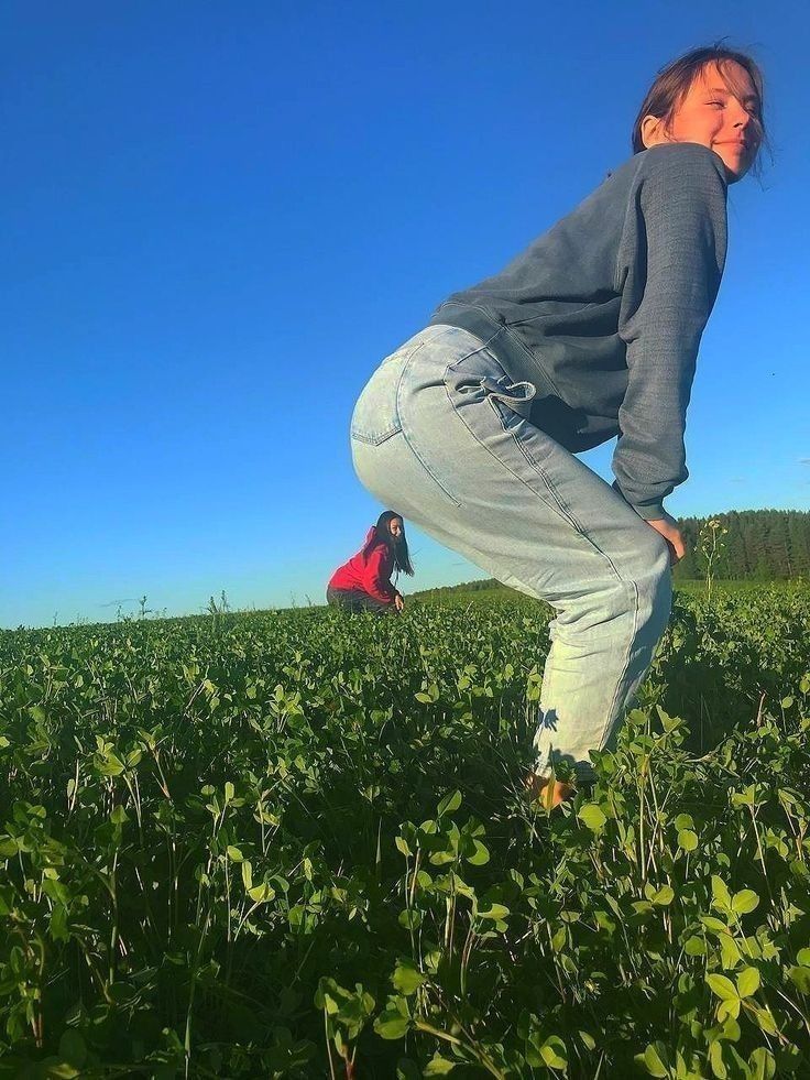 two people in a field with green plants