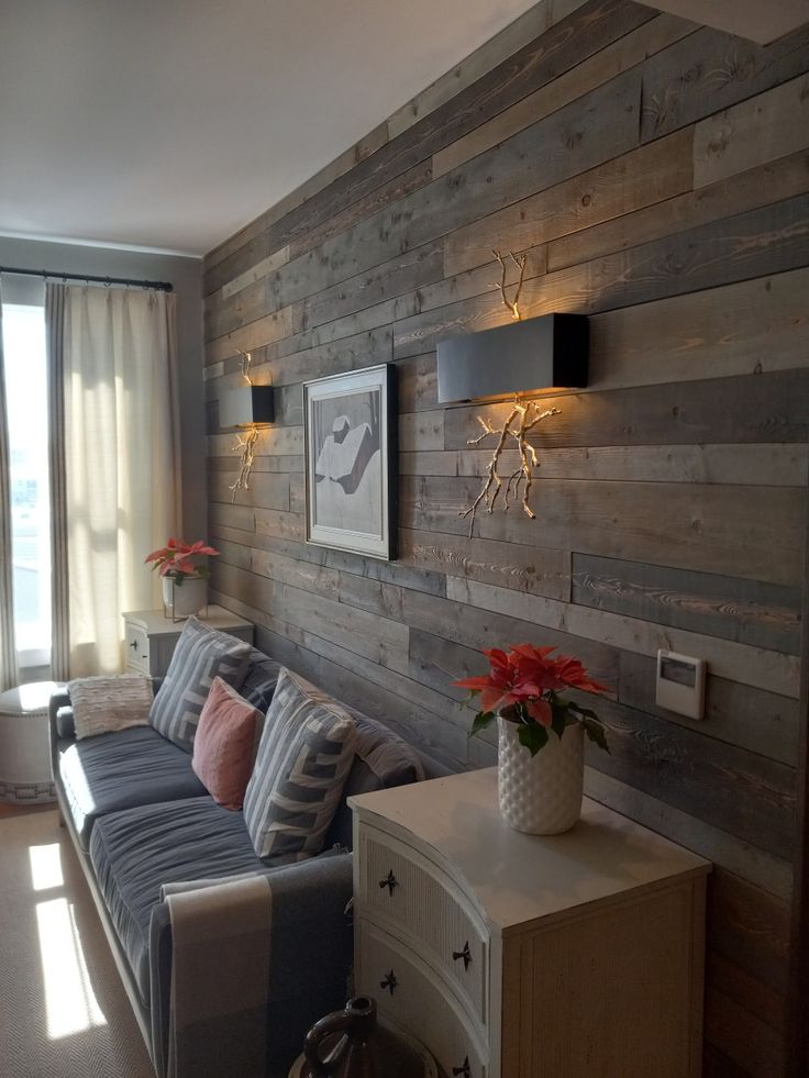 a living room with wood paneling on the wall