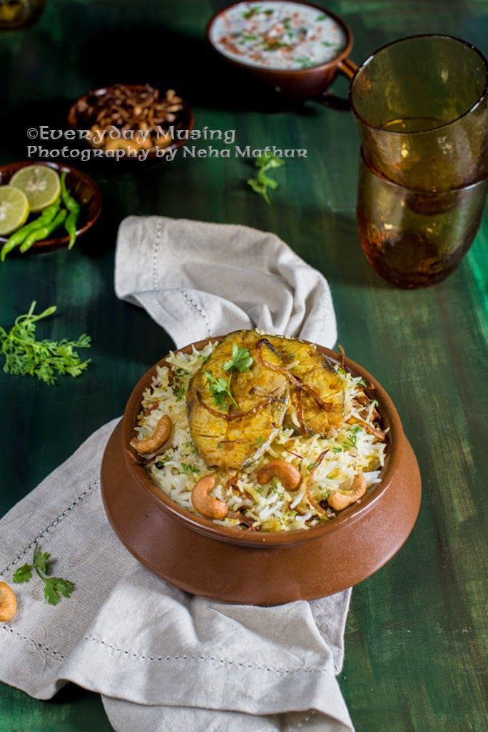 a bowl filled with rice and shrimp on top of a table next to other dishes