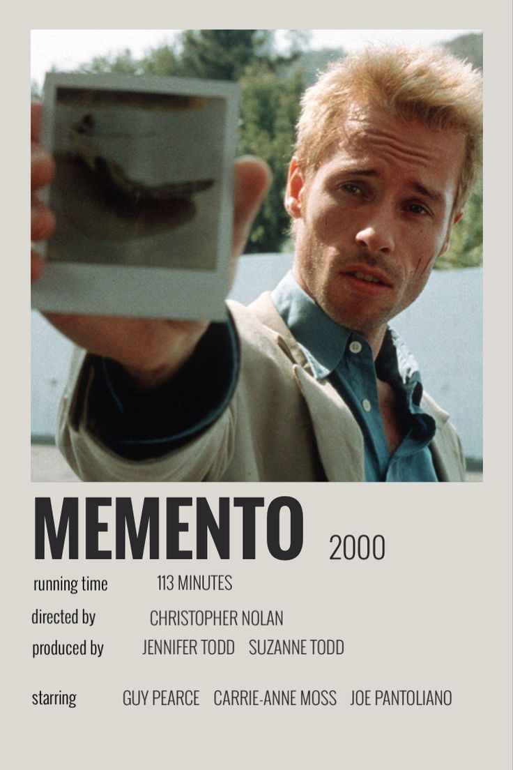 a man holding up a cell phone in front of his face with the caption mementoo 2000