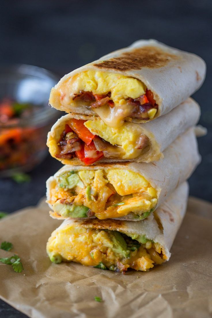 three breakfast burritos stacked on top of each other