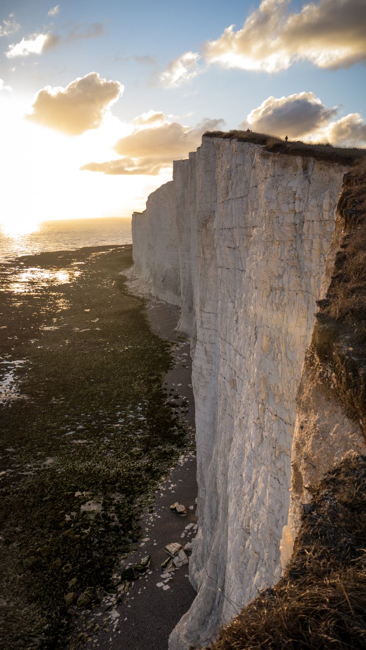 the sun is setting over the white cliffs