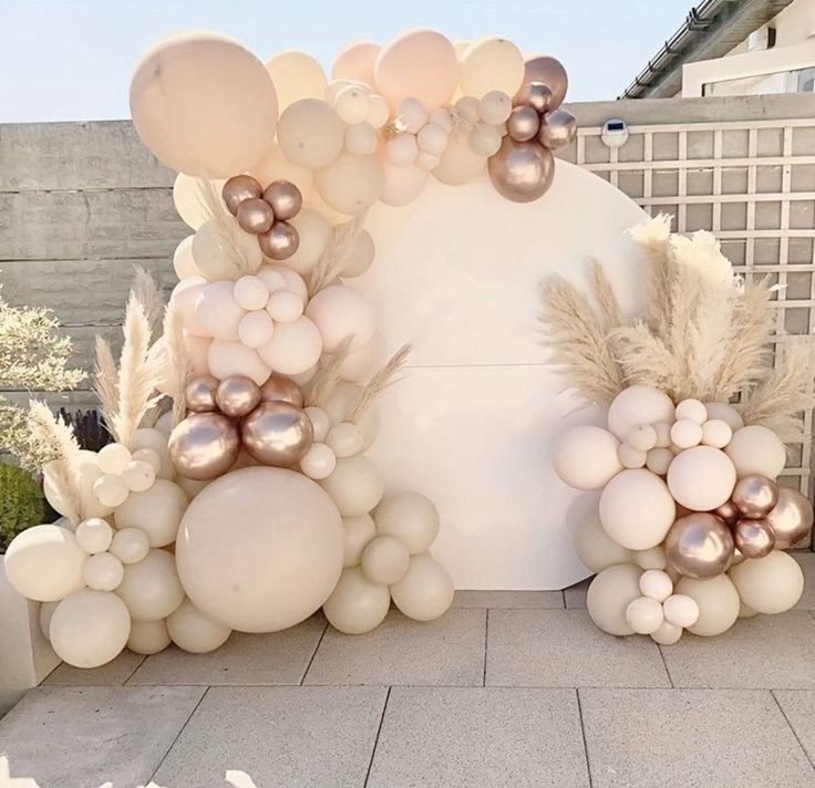 an outdoor area with balloons and flowers on the ground