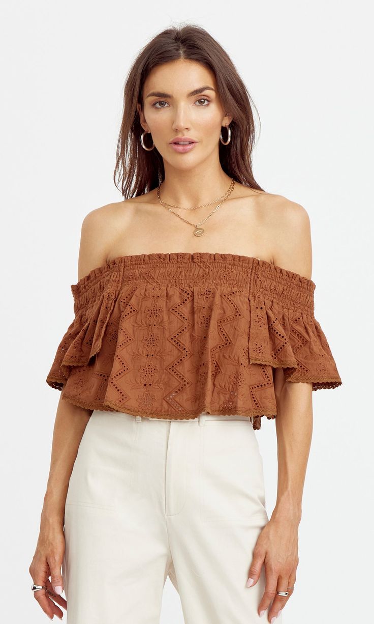 Off-shoulder blouse with ruffled shape and embroidered texture. The cropped piece is secured with an elastic. Embroidered Off-shoulder Self: 100% Cotton Length: 12" Chest:15" Hand wash in cold water. Lay flat to dry. Low iron. Model is wearing a size small Style #: G243T6980 Fitted Cropped Off-shoulder Top With Ruffles, Fall Ruffled Crop Top, Brown Smocked Top For Summer, Casual Cropped Off-shoulder Top With Ruffles, Summer Off-shoulder Crop Top With Smocked Bodice, Brown Off-shoulder Top For Spring, Spring Off-shoulder Crop Top With Smocked Bodice, Off-shoulder Crop Top With Smocked Bodice, Fitted Off-shoulder Smocked Top