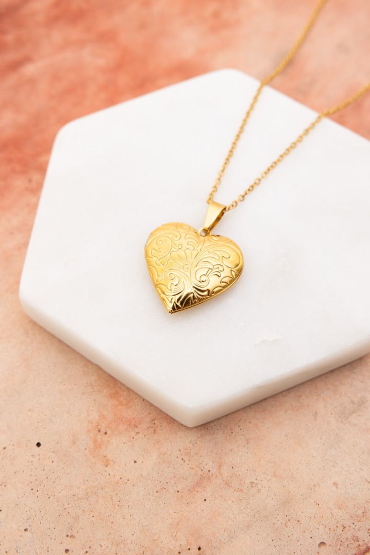 The Love Me Heart Heart Locket Necklace is the perfect way to show someone you care. Available in gold and silver, this cute necklace is a perfect gift for any occasion. Spread love and happiness with this adorable accessory. #lovemyleto #completeyourlook 100% Stainless Steel Imported Heart Locket Necklace Silver, Floral Engraving, Gold Locket Necklace, Heart Locket Necklace, Detailed Jewelry, Love And Happiness, Bull Skulls, Skull Necklace, Stone Pendant Necklace