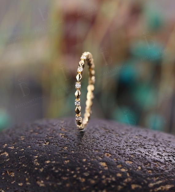 a diamond ring sitting on top of a rock