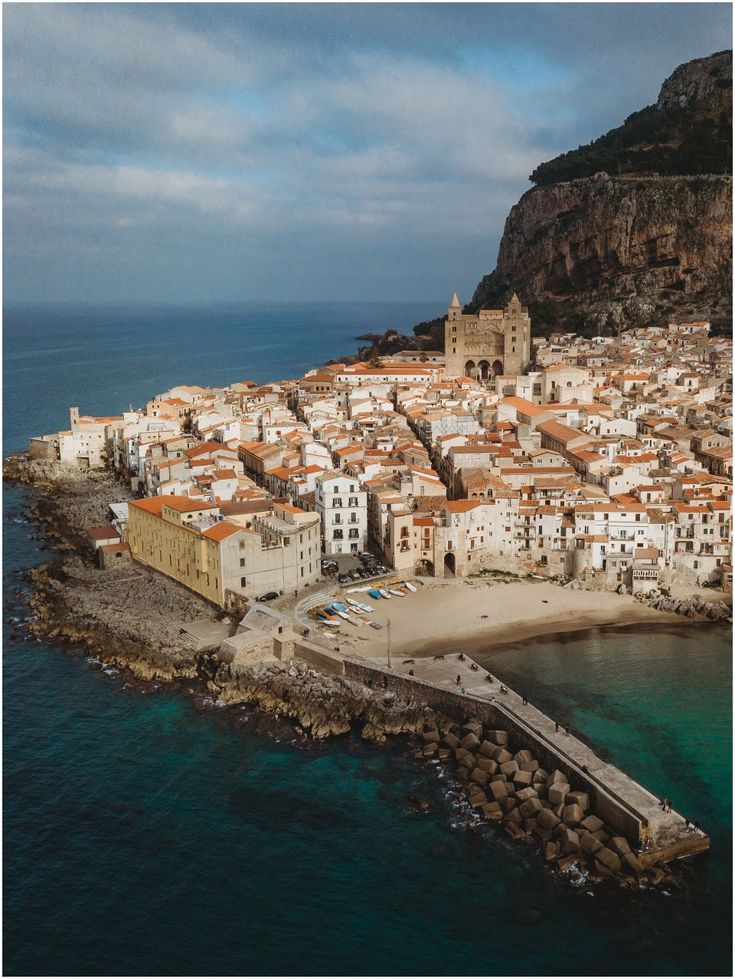 an aerial view of a small village on the coast