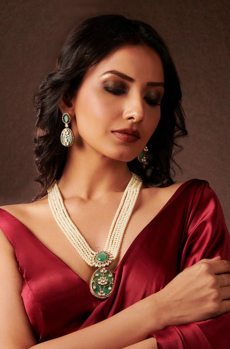 Elevate your style with this expertly crafted traditional necklace set, featuring Flourite stones, golden wire work, and cubic zirconia for added sparkle and elegance. The layered pearls and center polkis lend a touch of luxury and sophistication to any outfit. Complete the look with the included earrings for a polished and refined appearance. Finish: 22KT Gold Plating Material: Silver, Copper Alloy, Flourite Stones, Kundan Color: Mint Green Size: Free Size, Adjustable Closure Type: Draw String Elegant Kundan Necklace With Stone Work For Celebration, Elegant Meenakari Jewelry Sets For Reception, Elegant Kundan Necklace With Stone Work For Reception, Elegant Hand Set Chandbali Kundan Necklace, Elegant Kundan Necklace For Festive Reception, Elegant Chandbali Kundan Necklace Hand Set, Elegant Kundan Chandbali Necklace, Elegant Kundan Chandbali Necklace For Celebration, Elegant Bridal Necklace With Meenakari For Festive Occasions