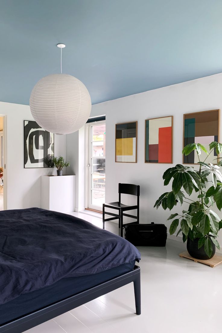 a bedroom with white floors and blue walls