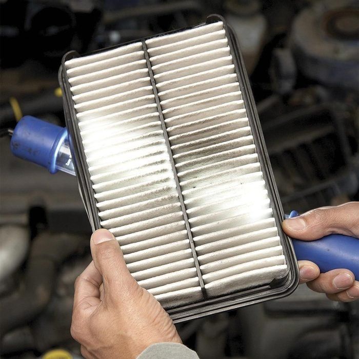 a person holding a air filter in their hand