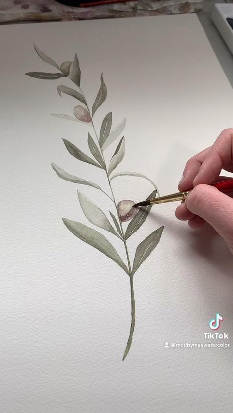 someone is painting a plant with watercolors on paper