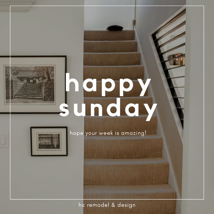 a staircase with the words happy sunday above it and pictures on the wall behind it