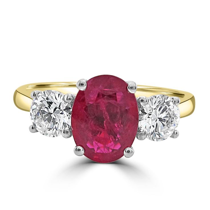 an oval ruby and diamond three stone ring