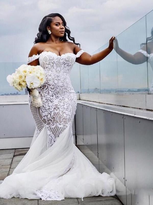 a woman in a wedding dress standing on a balcony with her arms out to the side