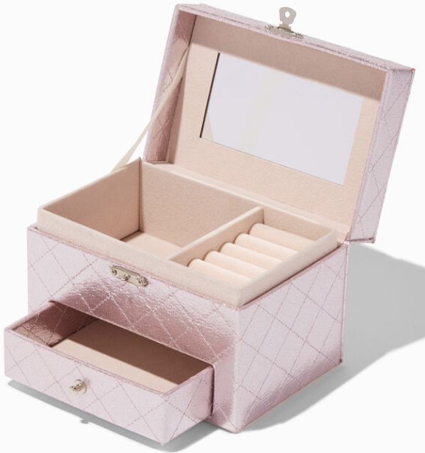 an open pink jewelry box sitting on top of a table