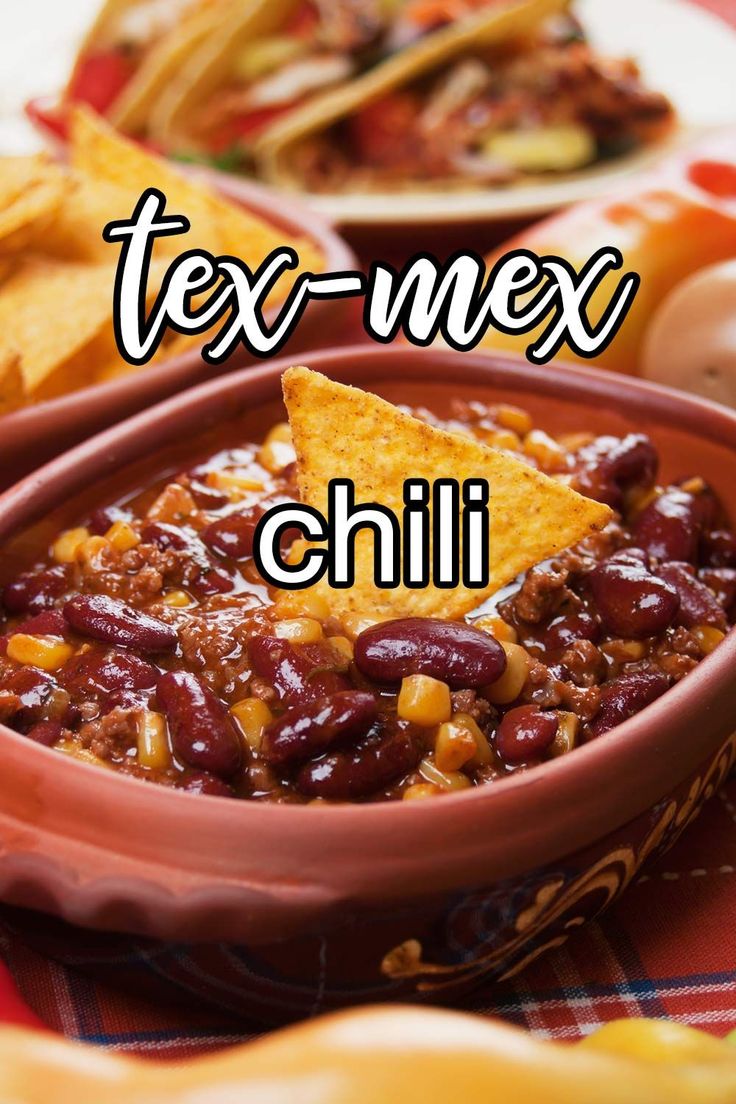 a bowl filled with chili next to tortilla chips