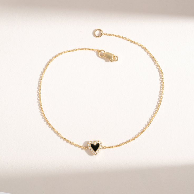 Lilliana Add a touch of sweetness and timeless elegance to your wrist with the Natural Diamond & Enamel Heart Bracelet. This delicate piece showcases a charming heart-shaped charm, meticulously crafted from 14k gold and adorned with sparkling natural diamonds and vibrant enamel. - Handmade- Solid Gold- Natural Diamond - G Color, SI Quality Diamonds- Total Diamond Carat Weight: 0.07 ctw- Dimension of Heart: 7 mm All pieces come beautifully boxed in suede pouches you can always use when traveling! Dainty Formal Bracelet With Heart Charm, Dainty Formal Bracelets With Heart Charm, Formal Dainty Bracelets With Heart Charm, Formal Dainty Bracelet With Heart Charm, 14k Gold Heart Bracelets Fine Jewelry, Yellow Gold Heart Charm Bracelet In Fine Jewelry Style, Dainty Heart Bracelet For Formal Occasions, Elegant Sterling Silver Heart Bracelet Gift, Elegant Bracelets With Heart Pendant And Adjustable Chain