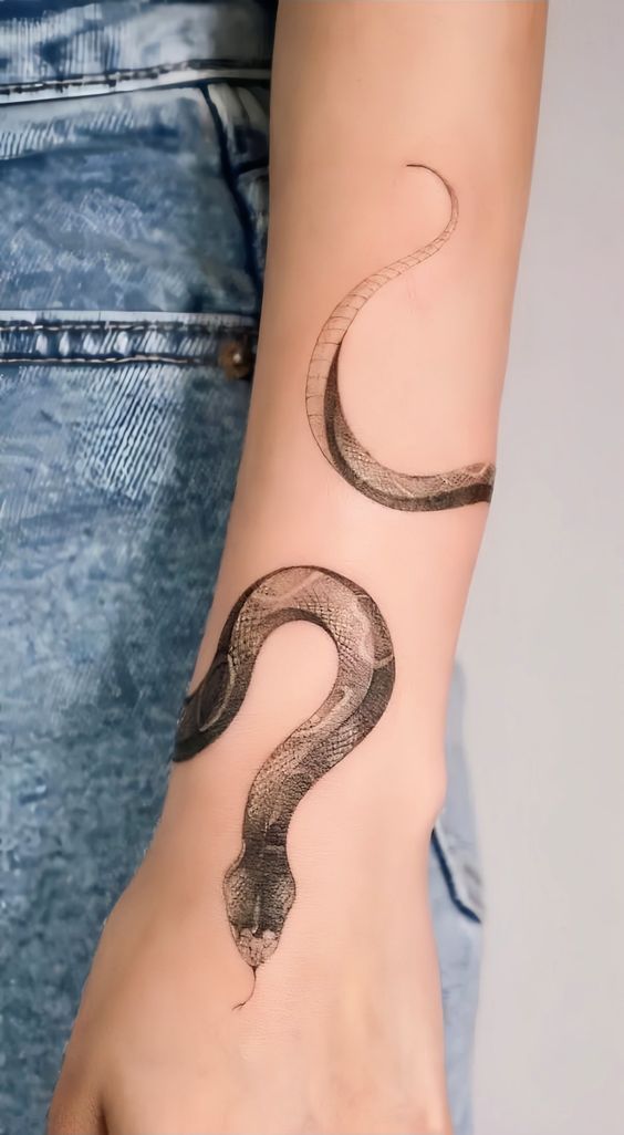 a woman's arm with a snake tattoo on it