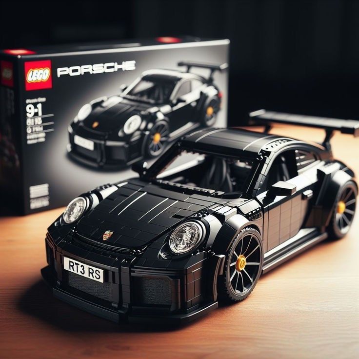 a lego model of a black porsche gtr on a table next to a box