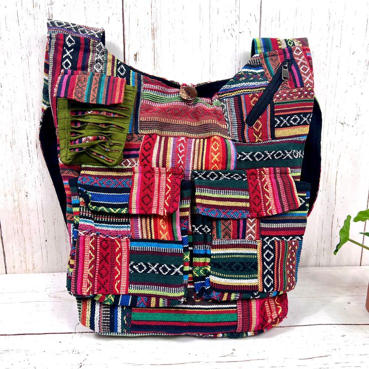 Elevate your bohemian style with our Handmade Gheri Cotton Patchwork Sling Bag, a unique and colorful accessory designed for those who appreciate artistry and functionality.Artisanal Craftsmanship: Handcrafted with care, each bag features a distinctive patchwork design using Gheri cotton, known for its durability and vibrant patterns. Multi-Pocket Design:Stay organized on the go with multiple pockets. This sling bag includes a spacious main compartment, two front pockets with Velcro closure, one Vibrant Patterns, Colorful Accessories, Patchwork Designs, Stay Organized, British Indian, Ethiopia, Pocket Design, Sling Bag, Bohemian Style