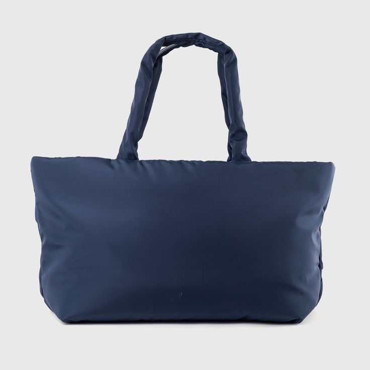 Holiday Essential Tote by Urban Originals is a chic, sustainable bag with a woven front made from recycled nylon. This versatile tote features multiple compartments and practical pockets, making it perfect for everyday use or a weekend getaway. Effortlessly combining style and functionality, elevate your look with this eco-friendly essential. Navy Nylon Bags For On-the-go, Weekend Nylon Bag With Zipper Closure, Functional Weekend Bags With Zipper Closure, Weekend Large Capacity Nylon Shoulder Bag, Functional Zipper Closure Weekend Bags, Modern Packable Tote Bag, Casual Nylon Tote Bag, Functional Nylon Shoulder Weekender Bag, Navy Nylon Bag With Pockets