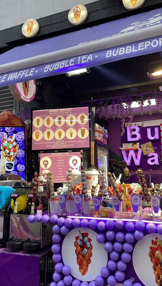 a purple and white display in front of a building with lots of decorations on it