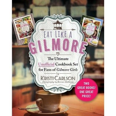 the cover of eat like a glimore cookbook on a table with coffee cups