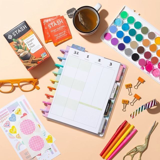 an assortment of stationery items on a pink surface