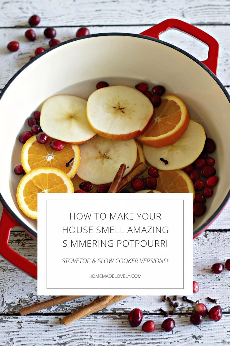 a pan filled with sliced apples and oranges on top of a table next to cranberries