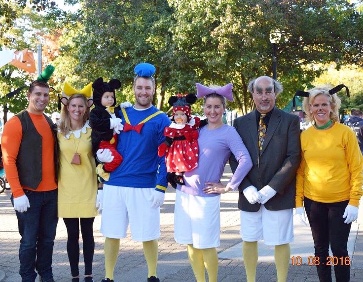 a group of people in costumes posing for a photo