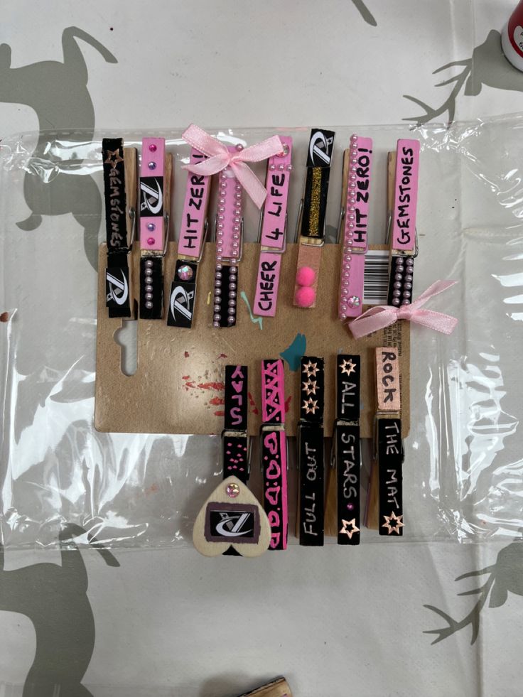 some pink and black items are laying on a plastic bag next to a toothbrush