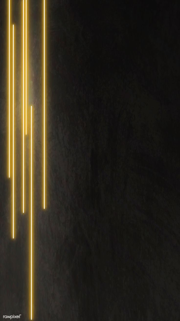 three yellow lights hanging from the side of a black wall in front of a dark background