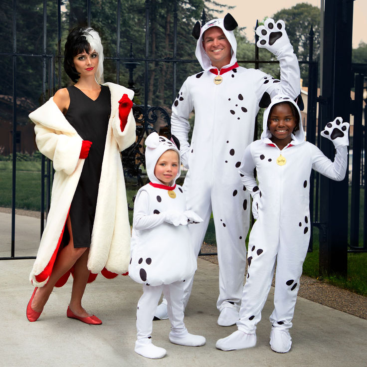 three adults and two children dressed up in dalmatian costumes