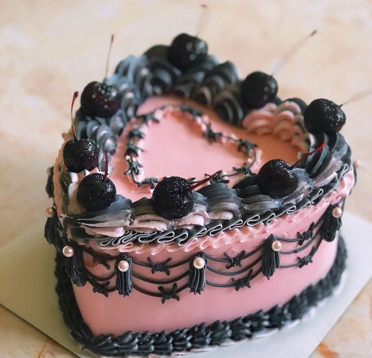 a heart shaped cake with blackberries on top