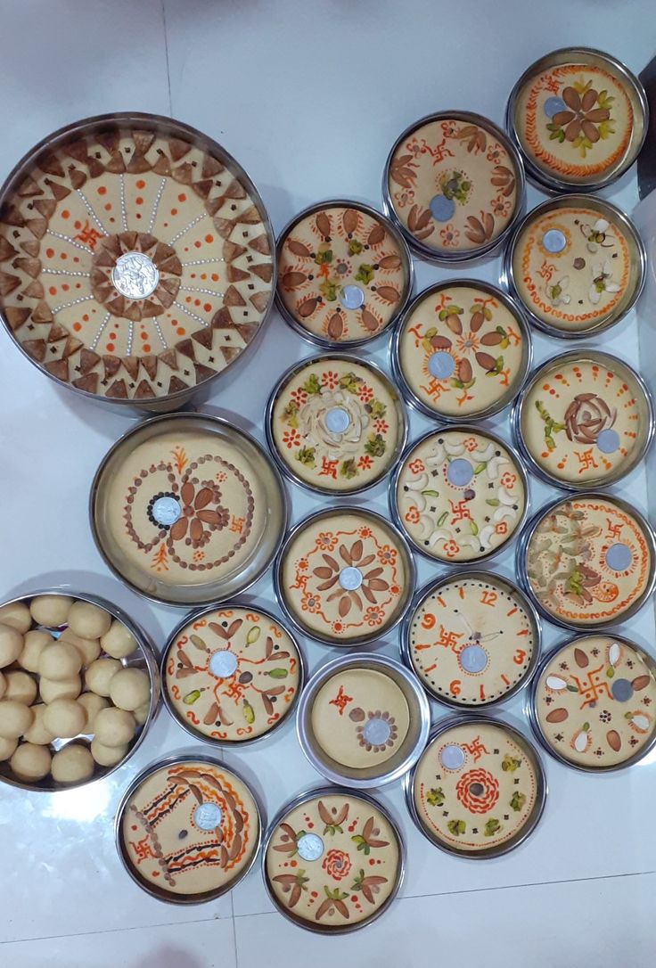 there are many plates and bowls on the table with food in each one, including nuts