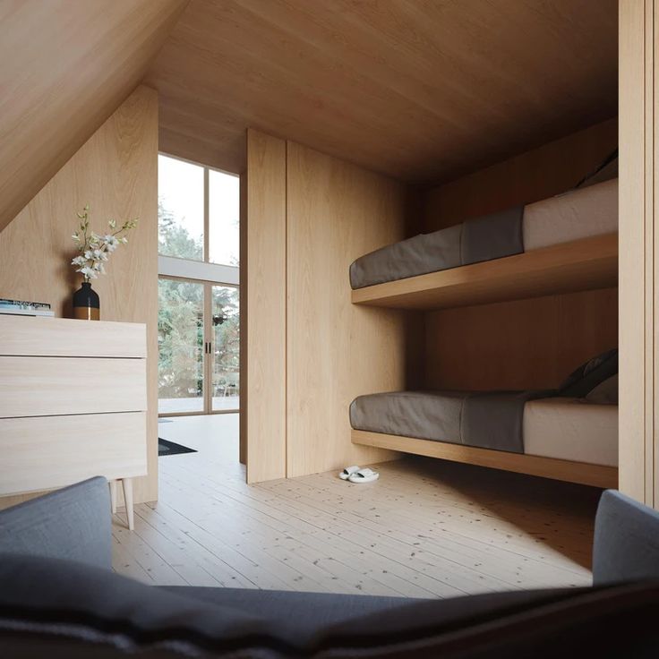 a bedroom with bunk beds and wooden walls