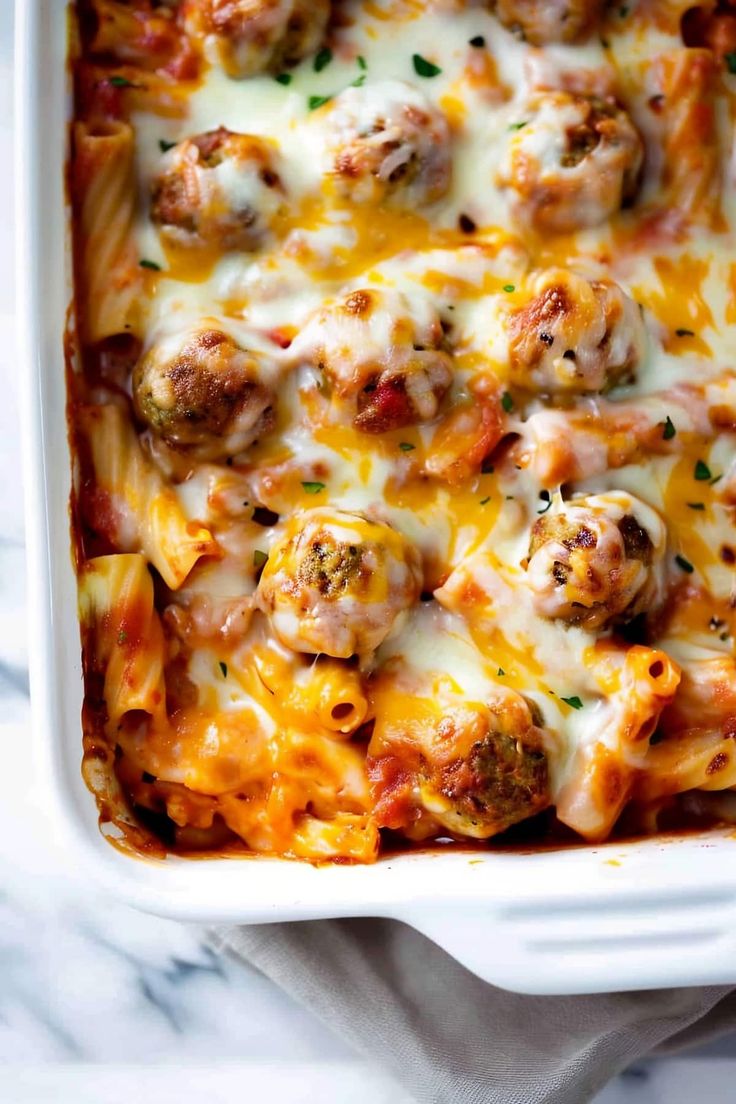 a casserole dish filled with meatballs and cheese